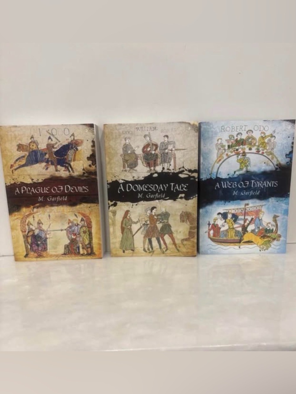 M. Garfield Trilogy:
A Domesday Tale A Plague Of Devils A Web Of Tyrants-Paperba